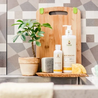 Chai nước rửa chén thiên nhiên Fuwa3e đặt cạnh bát đĩa sạch trên bàn gỗ